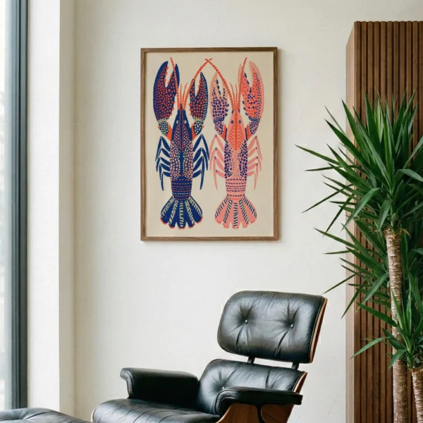 May include: A framed art print featuring two stylized lobsters. One lobster is primarily blue with red accents, and the other is pink with blue accents. The artwork is set against a beige background and framed in a wooden frame. The print is displayed in a modern living space.
